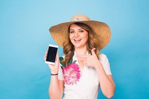 スマホを指しながら笑う女性