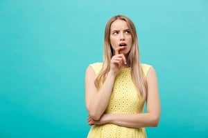 困った表情の黄色い服を着た女性