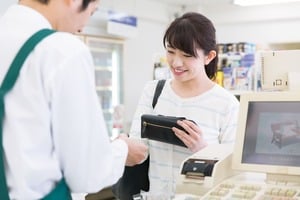 デビッドカードでキャッシュレス決済をする女性